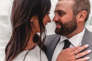 An intimate wedding portrait showing a tender moment between newlyweds.