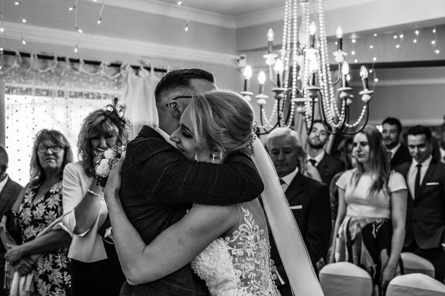 Couple hugging during wedding service in Wales