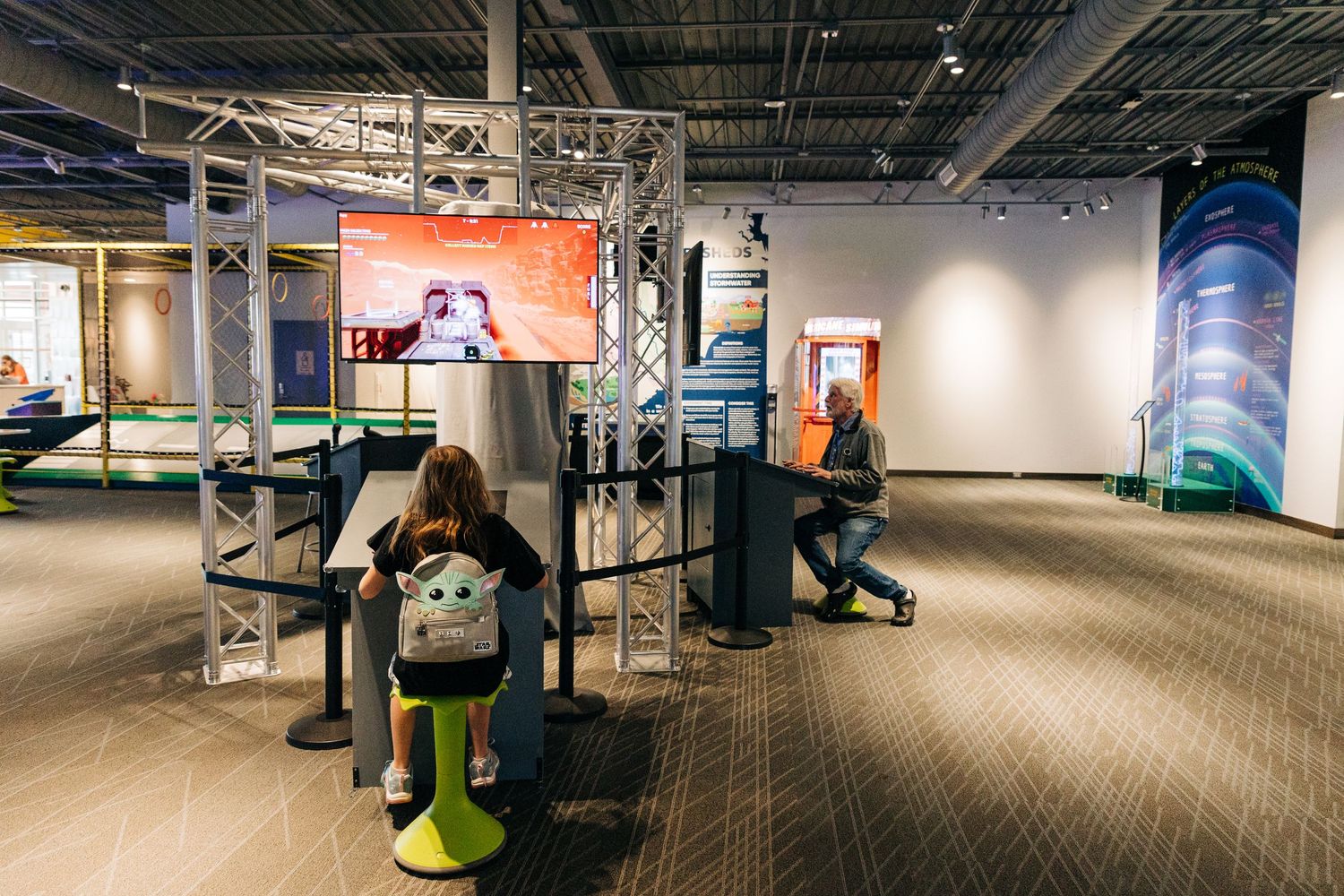 girl and man playing games at Monroe Science Center