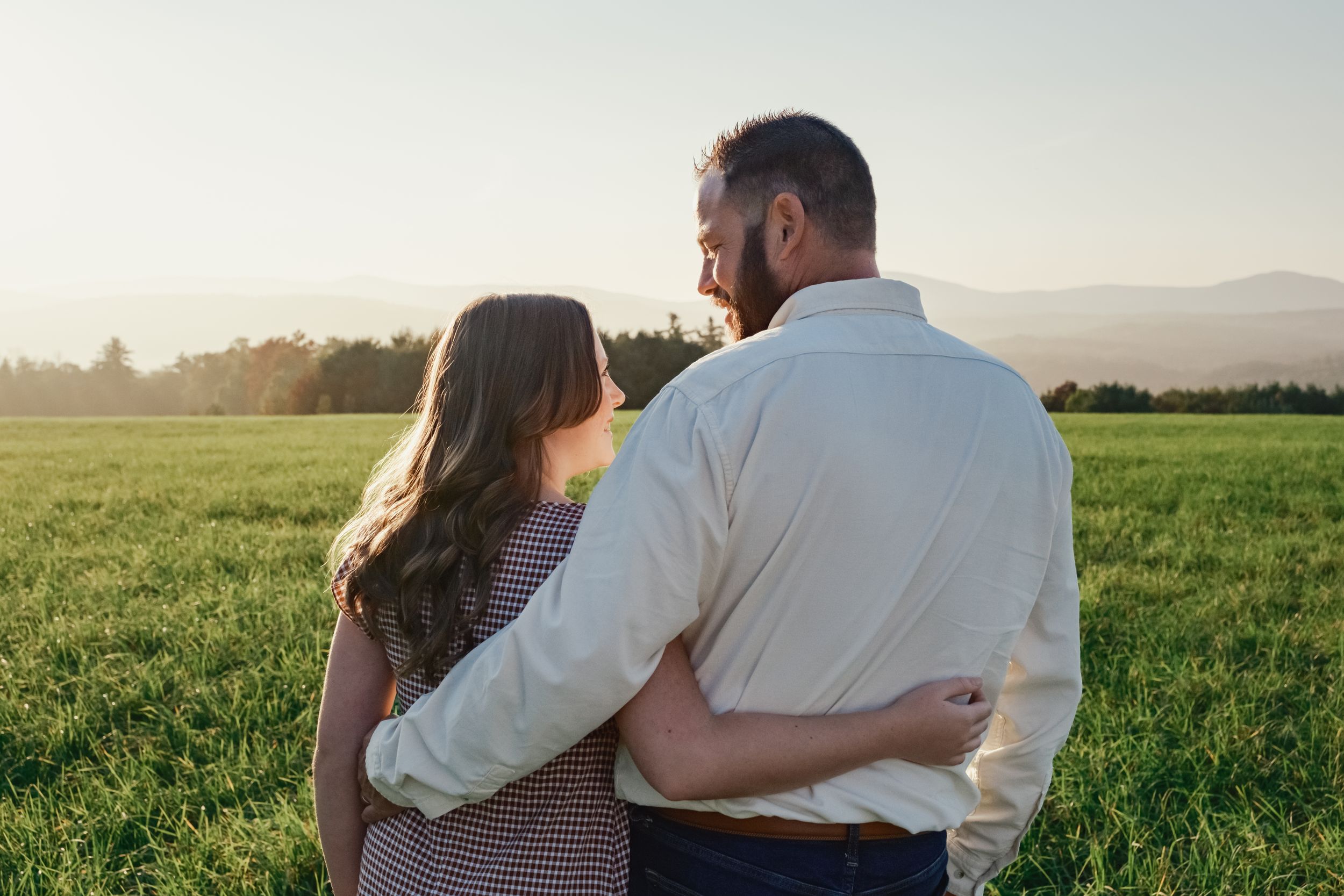 Dad and daughter with their backs to the lense looking at eachother