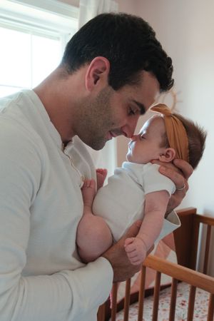 dad touching nose with baby