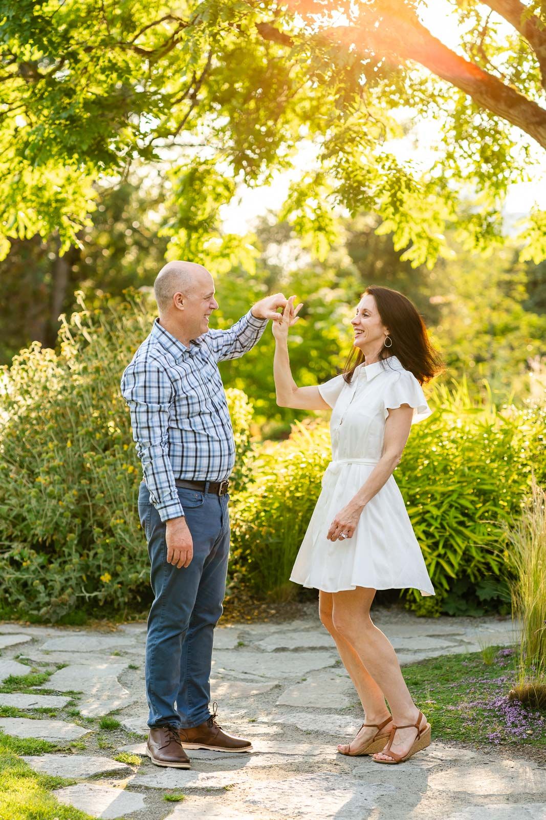 Candid moment of husband dancing with wife.