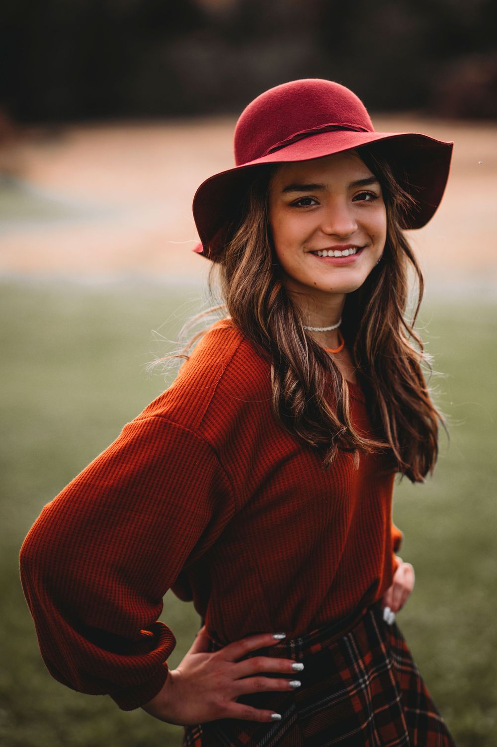 Senior girl posing in fall colors with hat in Orr, Minnesota.