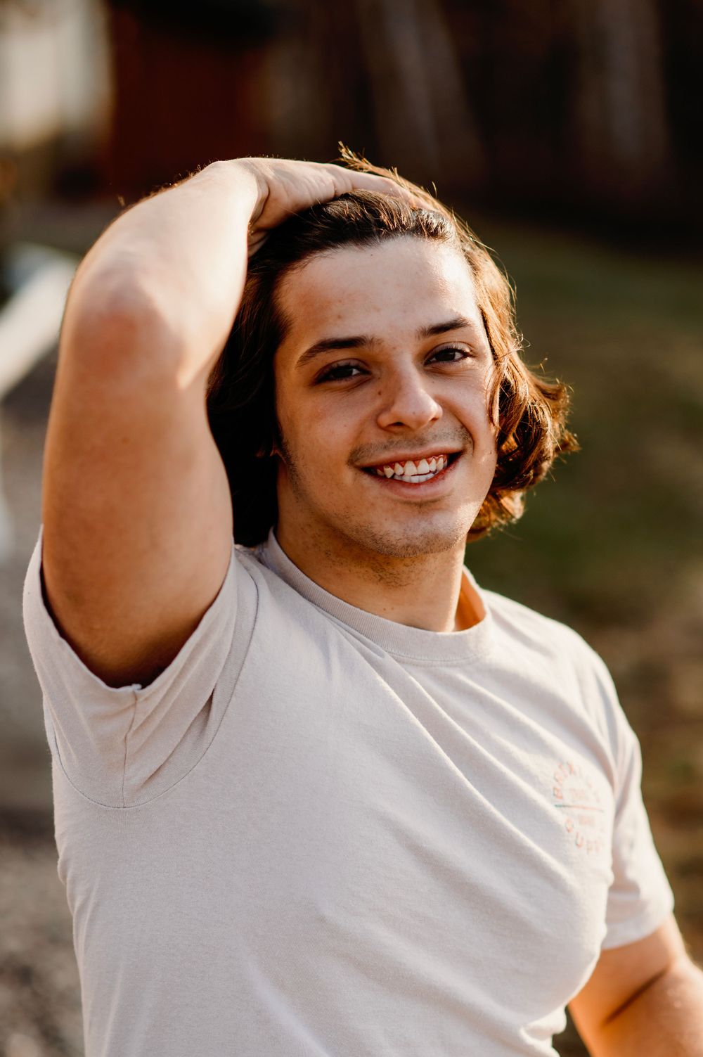 Senior guy smiling in white tee shirt in Orr, Minnesota.