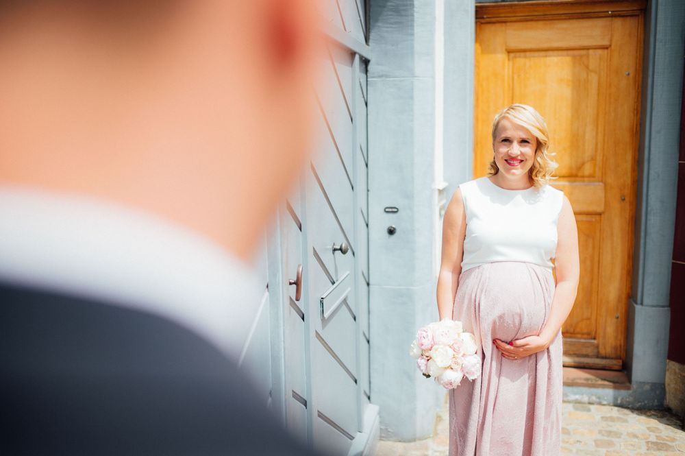 Elegant formal wear against the backdrop of a vintage wooden door and blue wall.