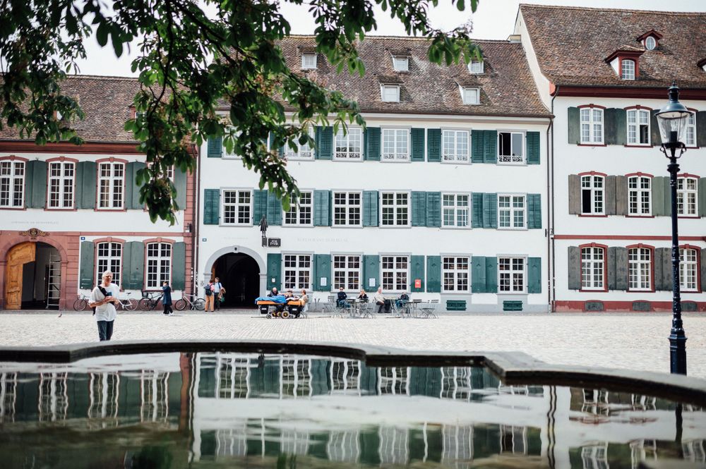 Historic European buildings with traditional architecture reflecting in calm water.