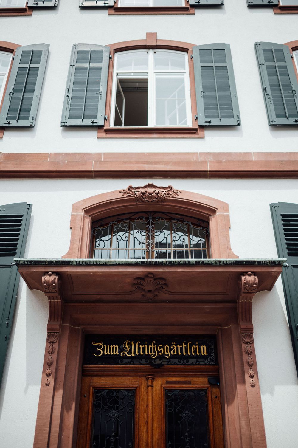 Traditional German building facade with ornate doorway and 'Zum Ulrich-gartlein' signage.