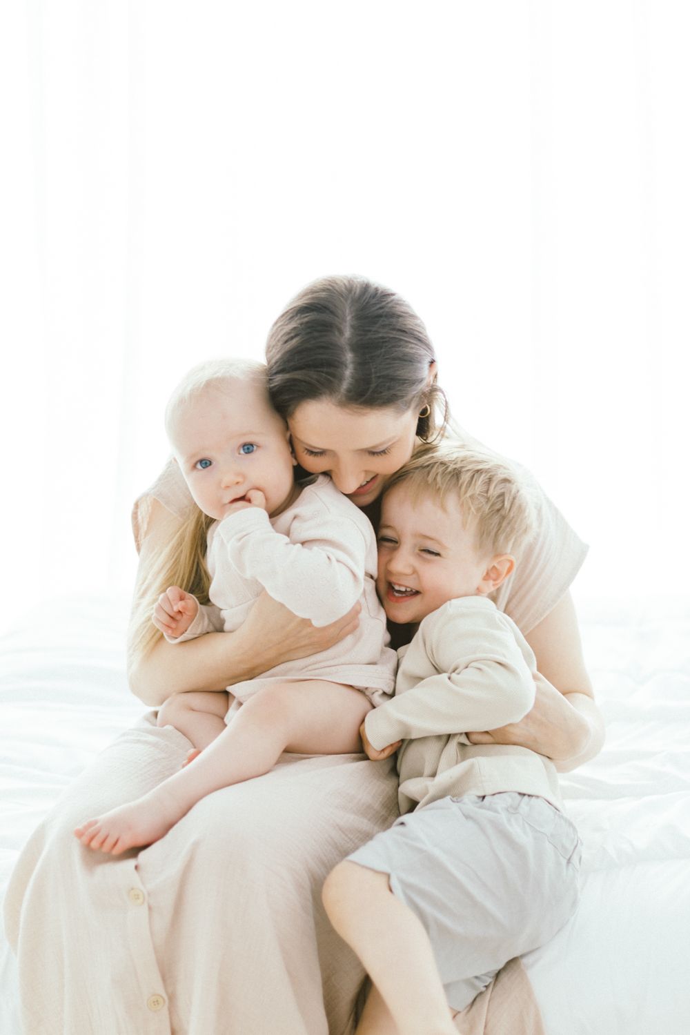 Intimate family portrait showing warm embrace on white background.