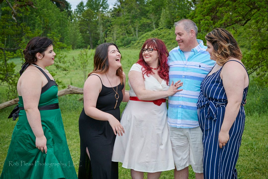 Wedding at Fort Steilacoom, Lakewood, WA, in May.  Daughters hugging wedding couple.