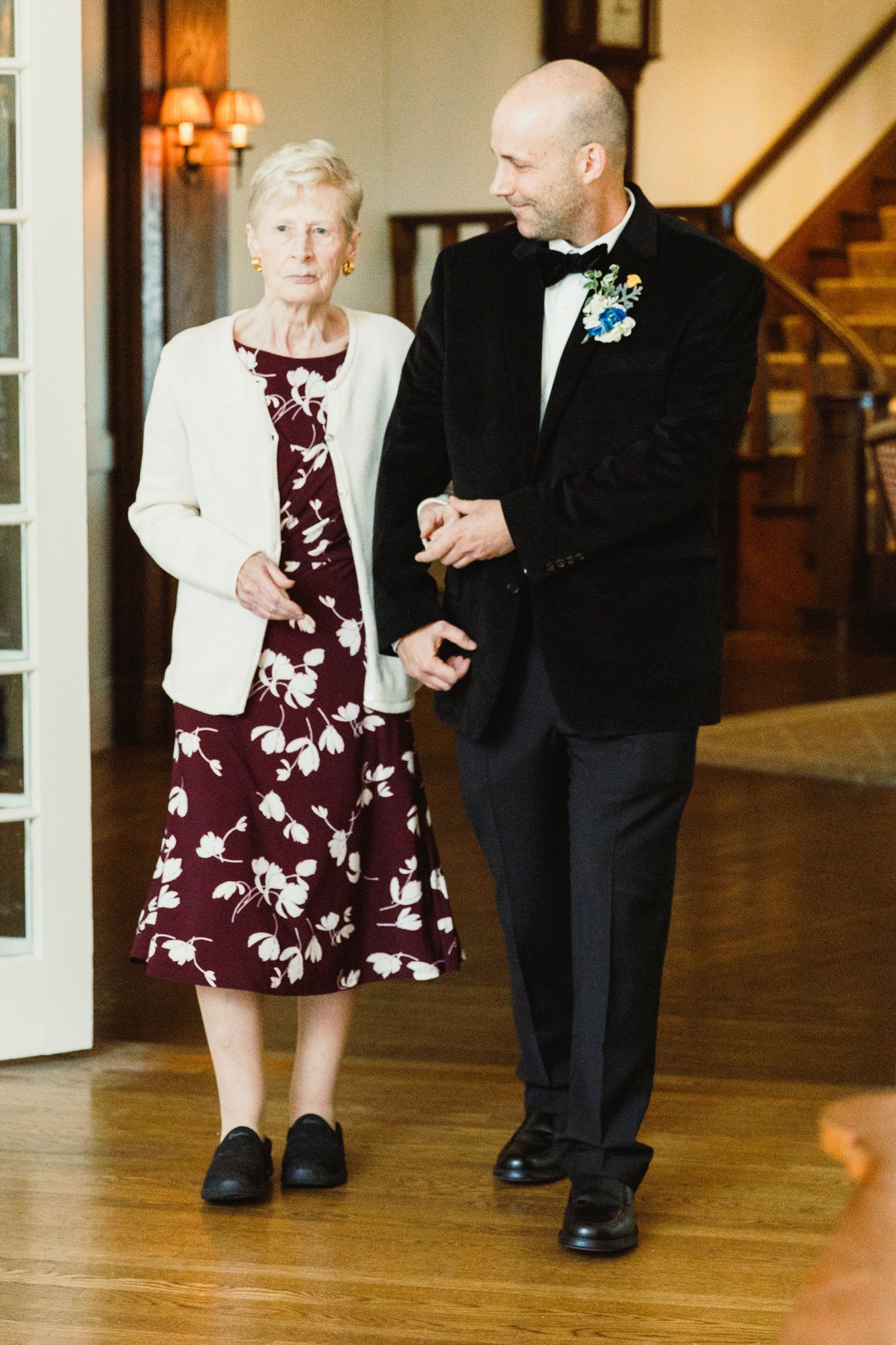 Guests dancing on hardwood floors at an elegant indoor venue.