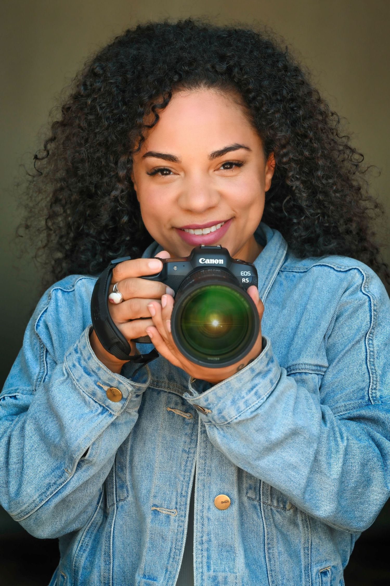 Creative portrait series showing photography poses with a camera and denim jacket.