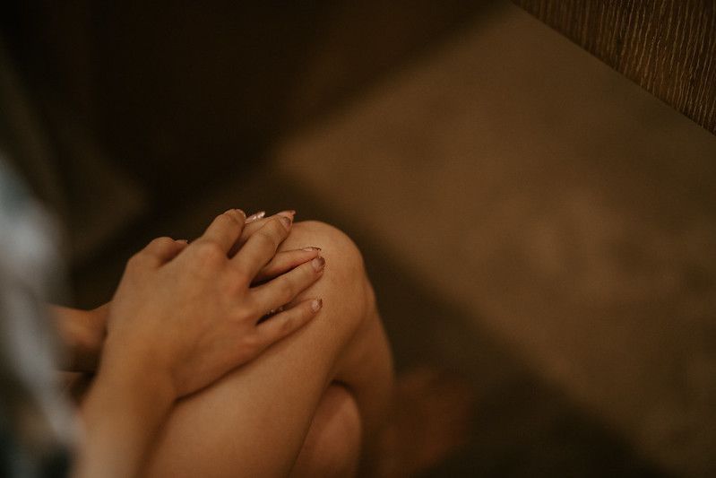 Intimate close-up shot of hands with soft, moody lighting.