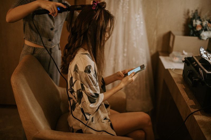 Wedding day preparation scene in warm, vintage-style lighting.