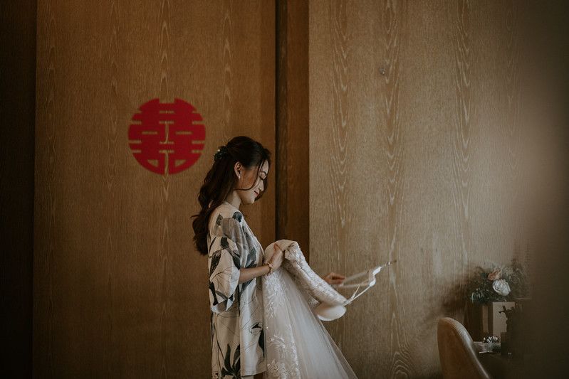 Hotel room interior with traditional Chinese double happiness symbol on wall.