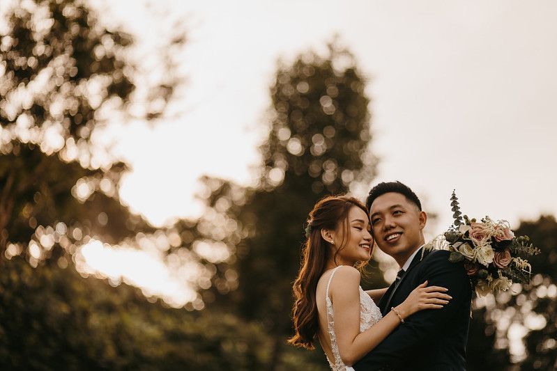 Newlyweds share an intimate moment during their sunset wedding photoshoot.
