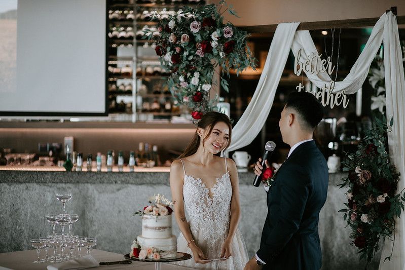 Intimate wedding reception moment captured in moody lighting with decorative elements.