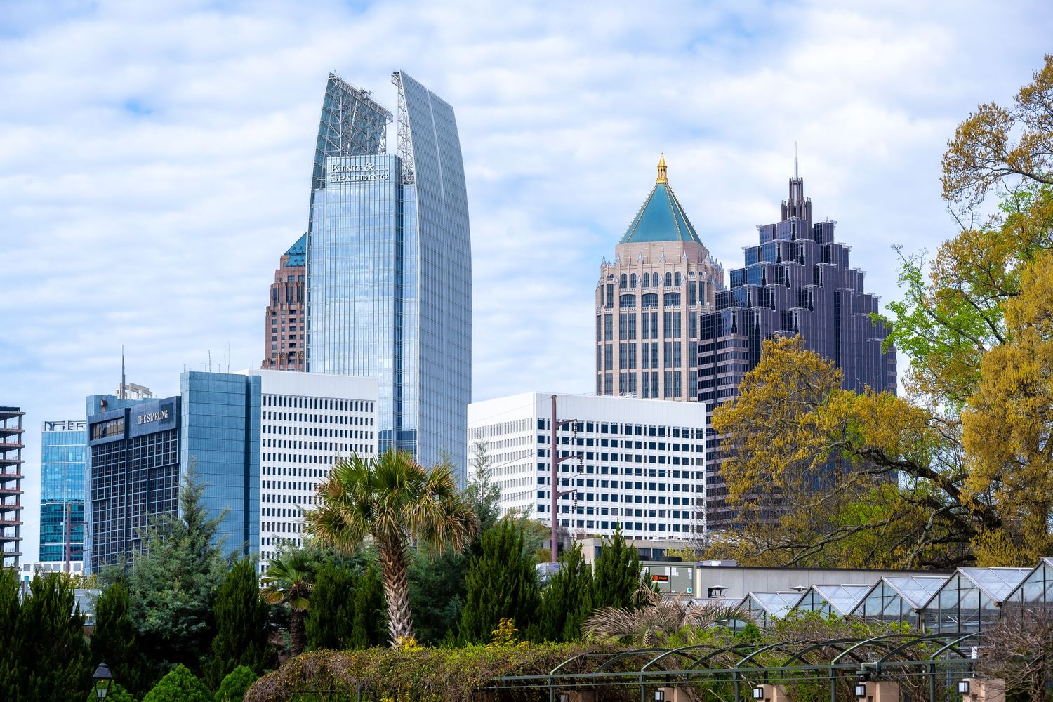 Atlanta's distinctive downtown skyline featuring modern glass skyscrapers against blue sky.
