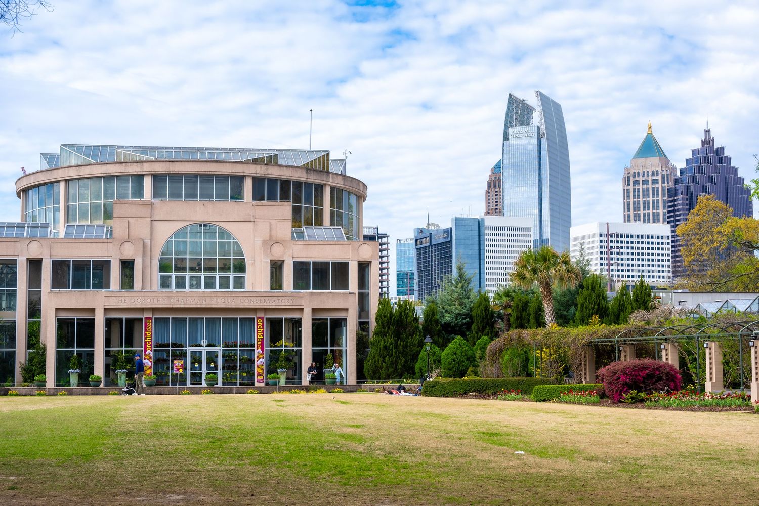 Historic building with arched windows set against Atlanta's modern city skyline.