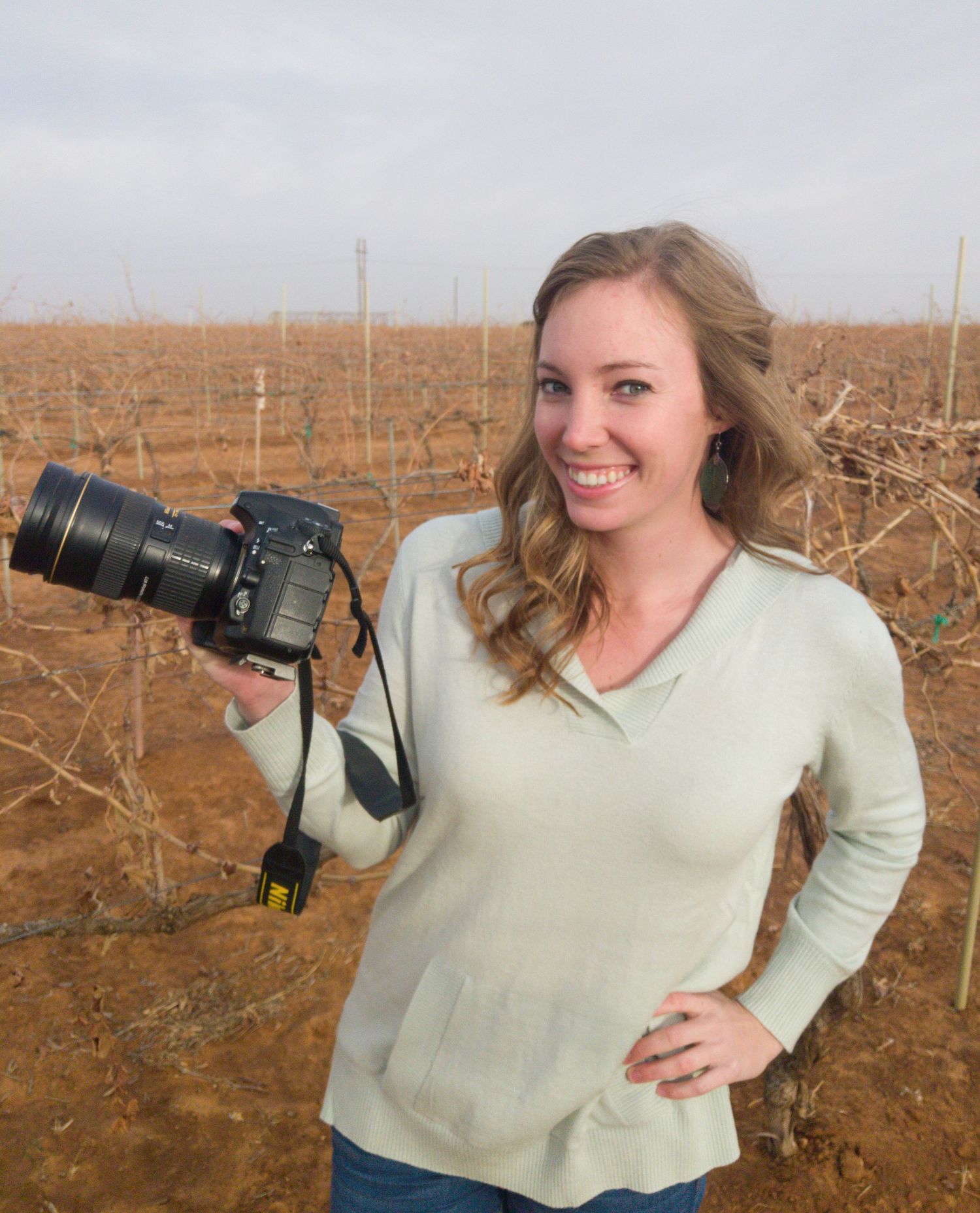 Louisa Sanchez holding a camera - Lubbock Photographer