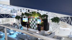 An elevated view of an event setup with striped furniture and green wall accents.