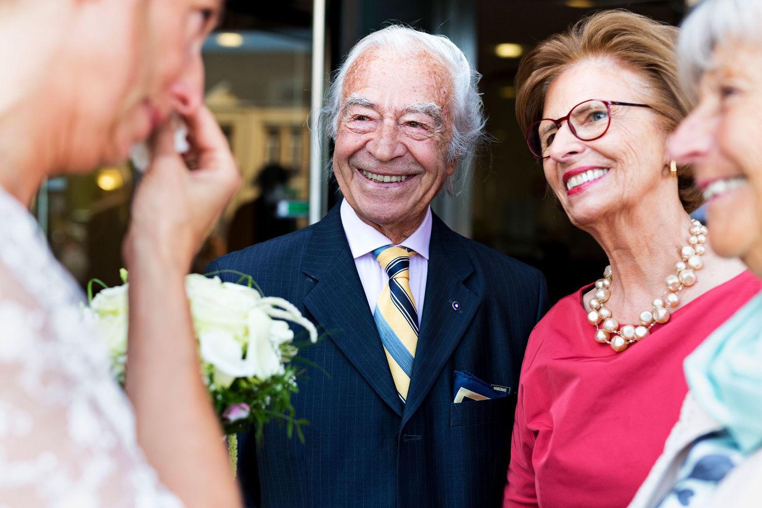 Elegant wedding guests sharing a joyful moment at a formal celebration.
