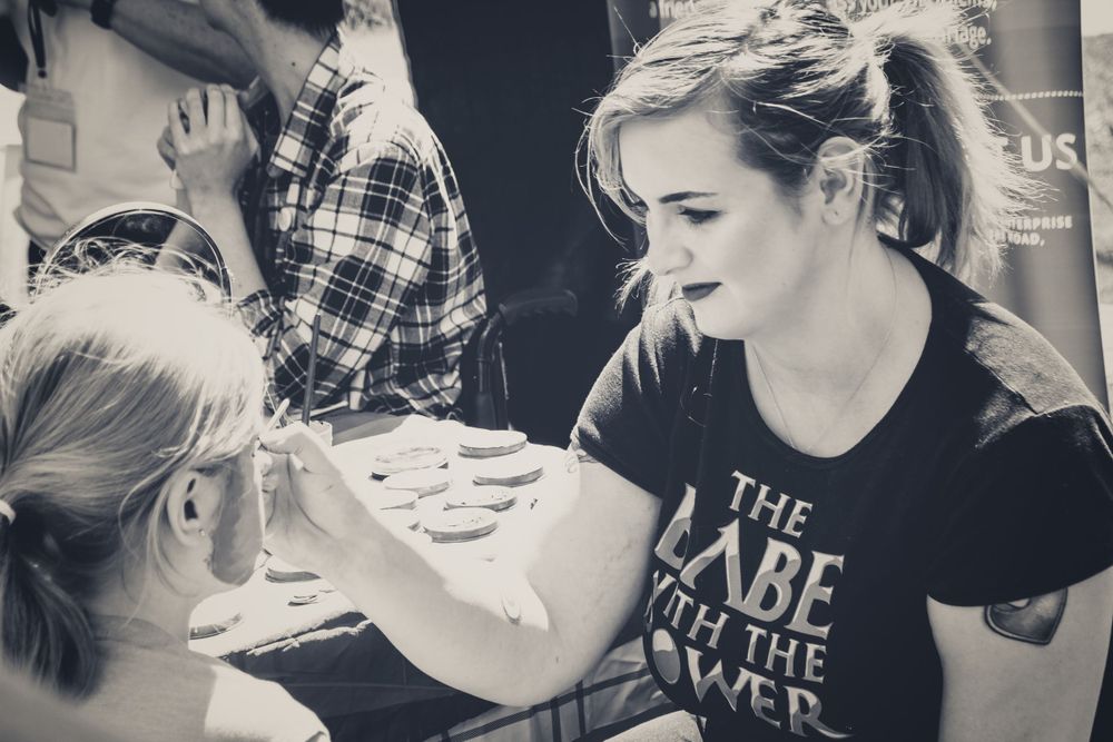 A candid black and white photo showing people sharing a laugh together.