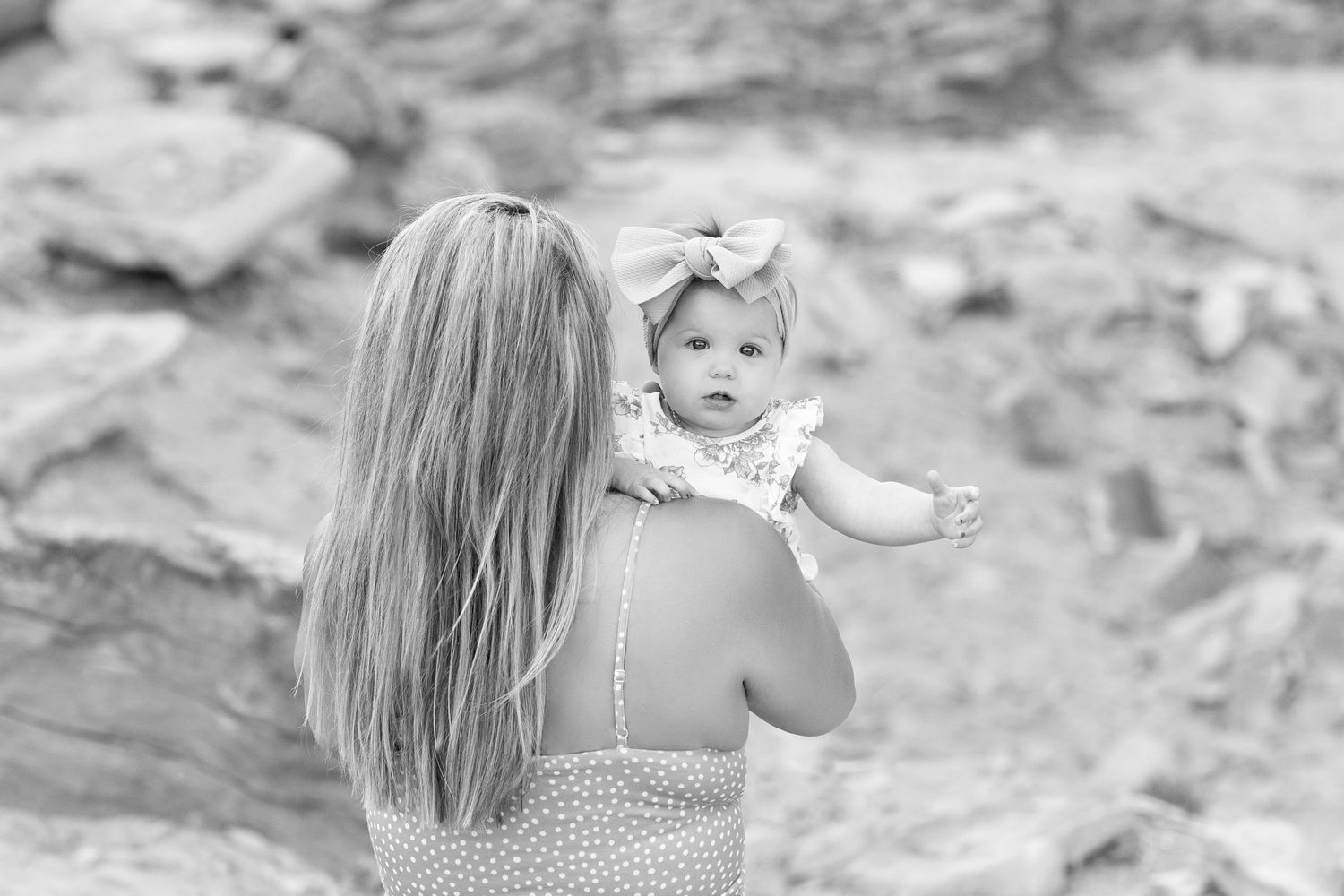 Black and white intimate portrait of family members sharing tender moments.
