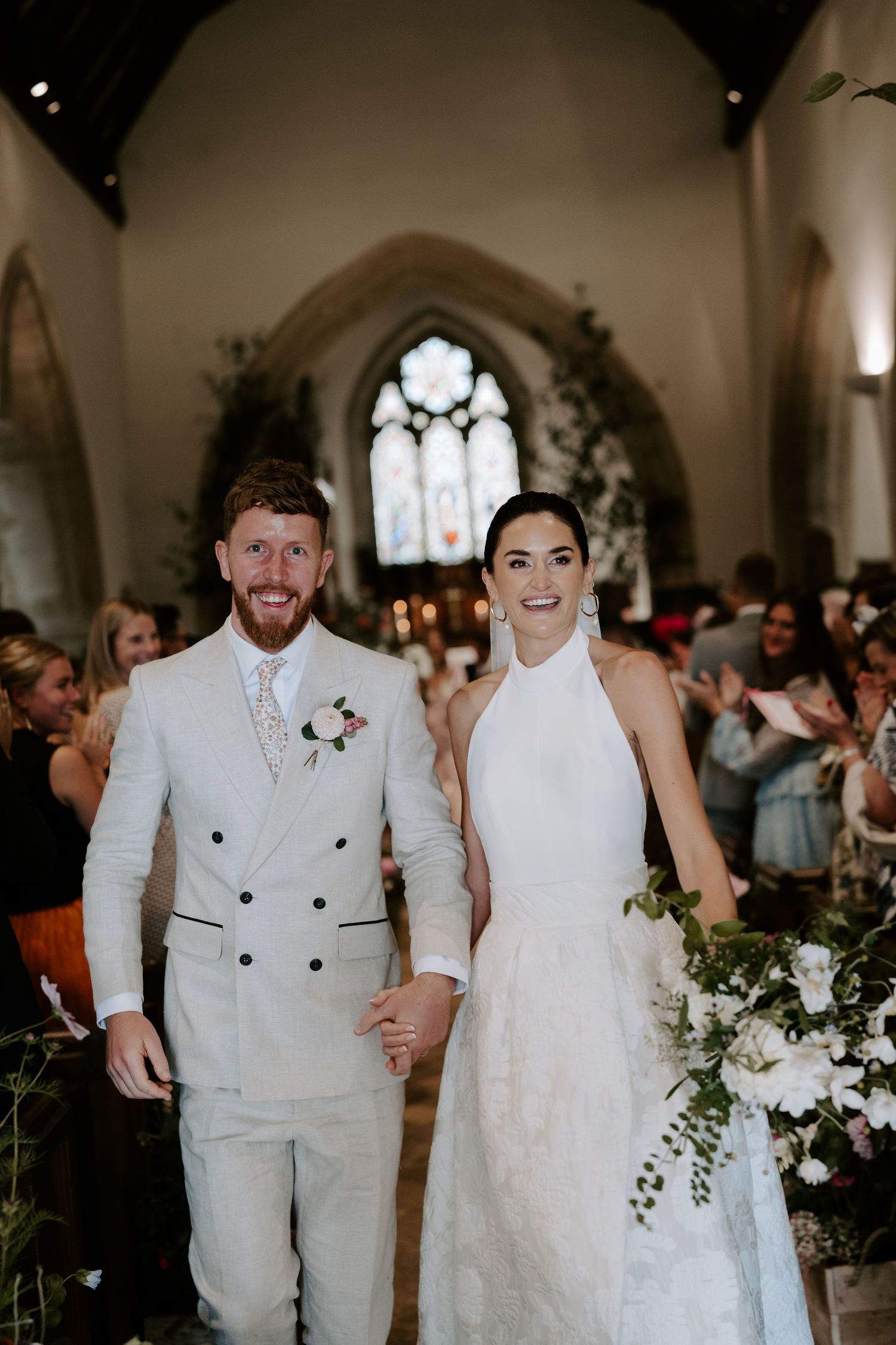 bride and groom exiting the church as newlyweds at st Nicholas church in Oxfordshire