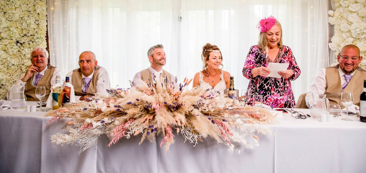 Wedding reception guests enjoying a festive moment with laughter and celebration.