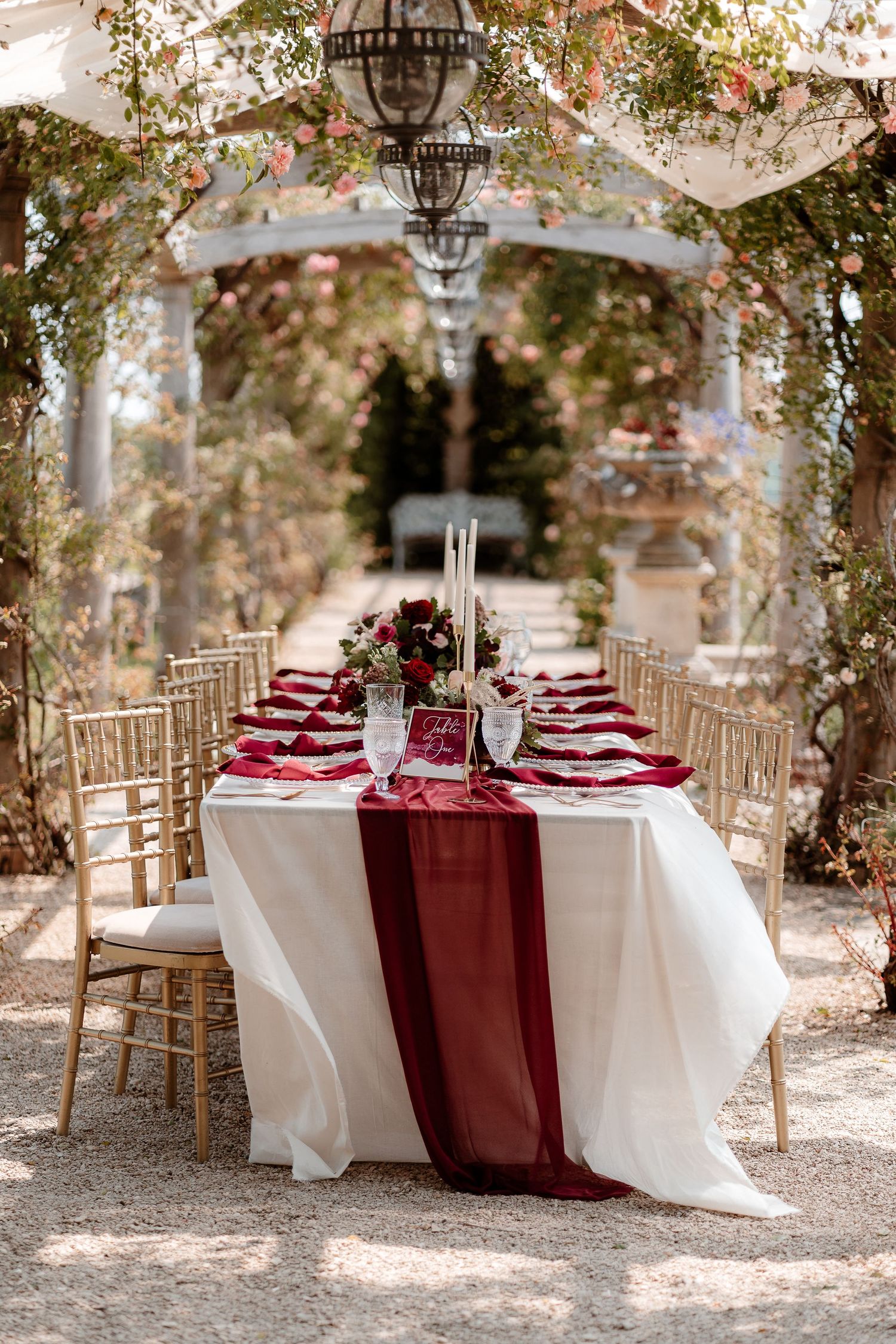 View of an al fresco wedding breakfast table under the pergola at Euridge Manor, luxury Cotswolds wedding venue