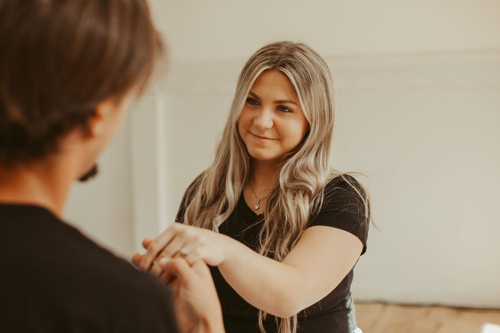 Casual couple shares playful moments during indoor lifestyle photography session.