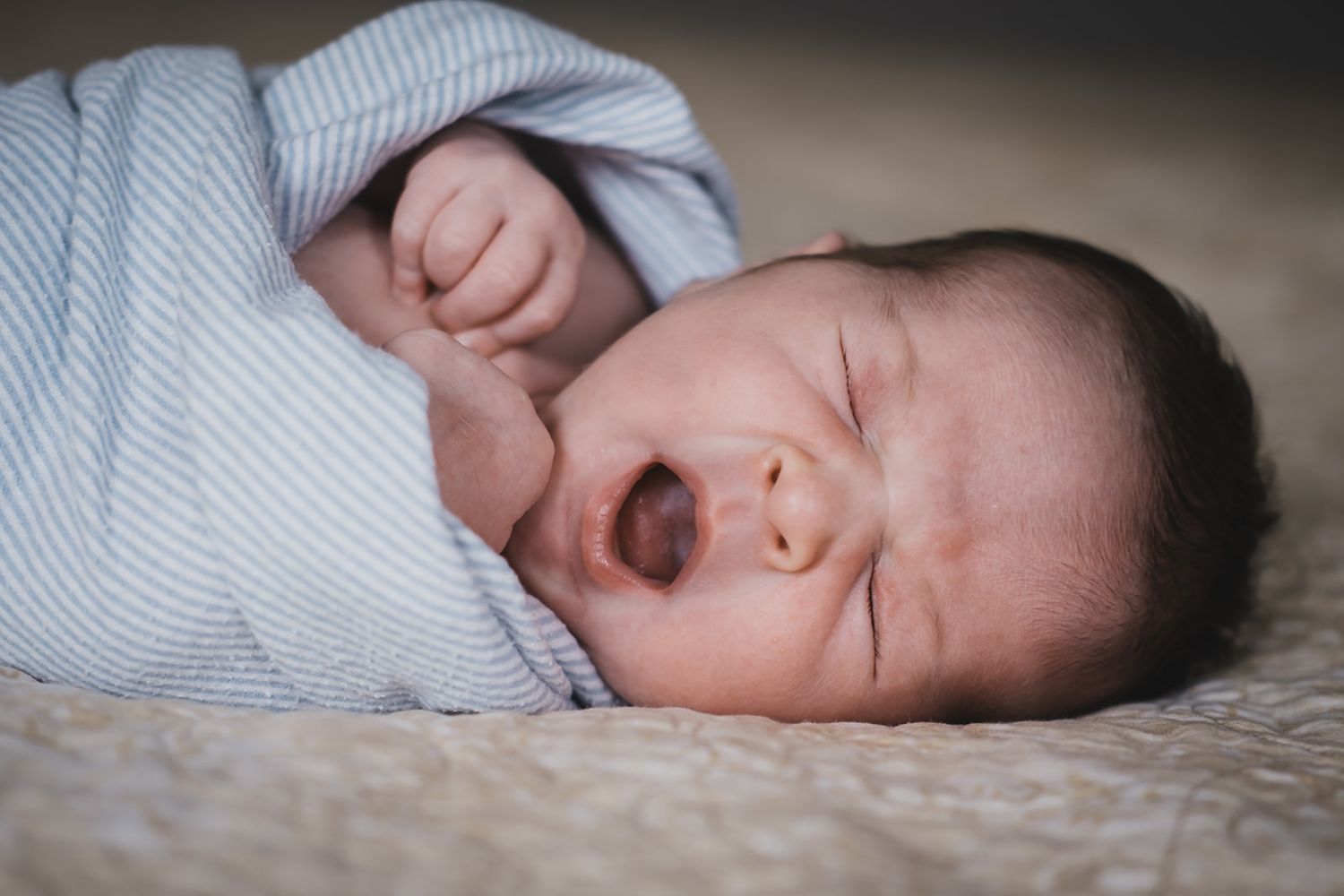 Newborn baby yawning at his home in Layton, Utah with Michelle Deppe.