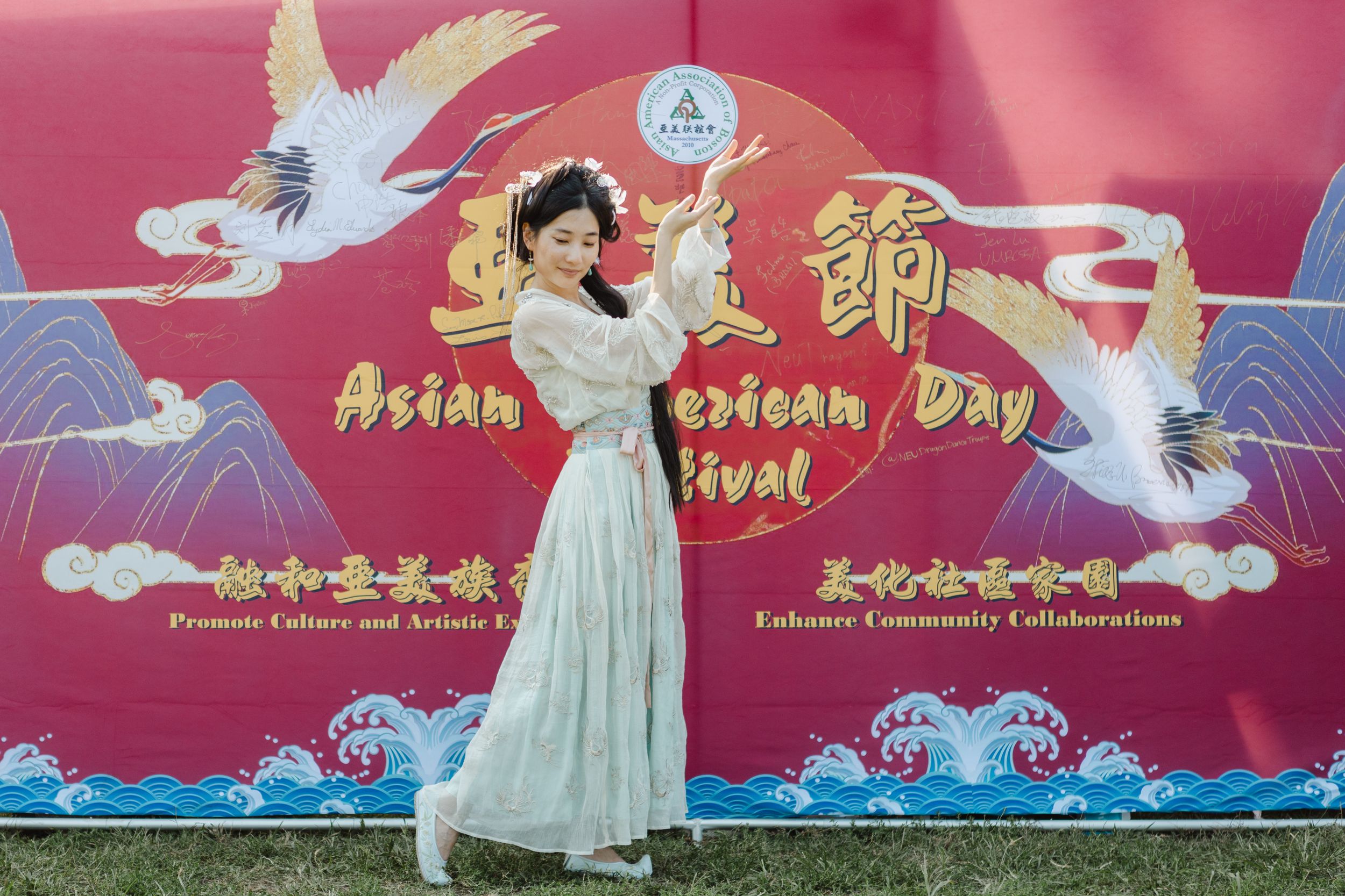 Decorative banner with white cranes and traditional Asian artwork hangs against a red background.