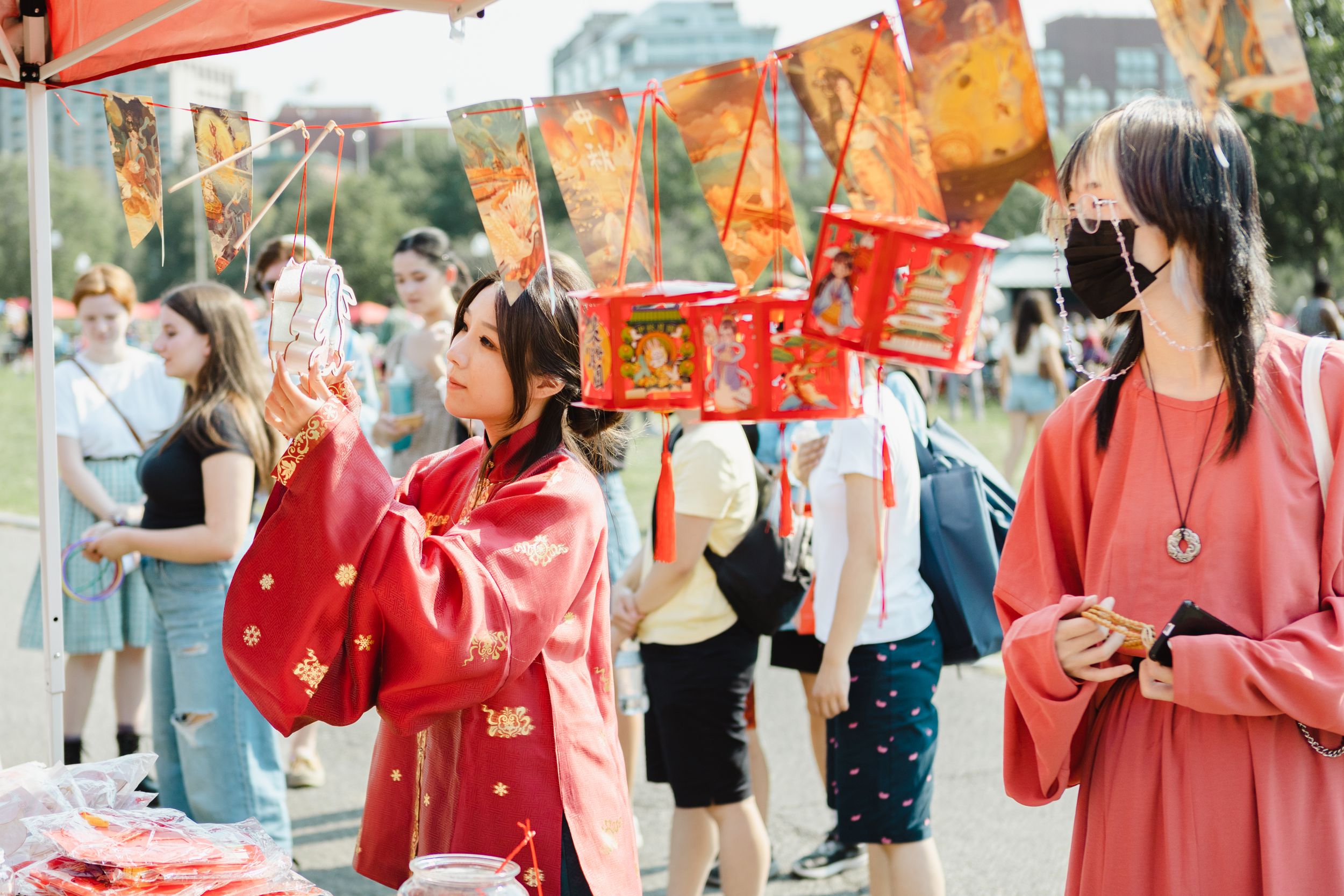 Festive red decorations and banners displayed at an outdoor cultural celebration.