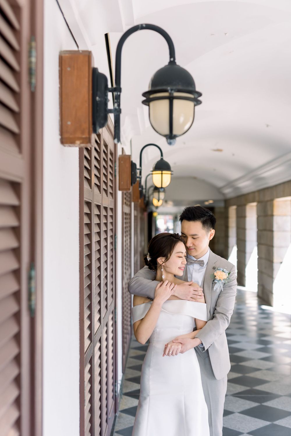 An intimate wedding portrait in a hallway with classic architectural details.
