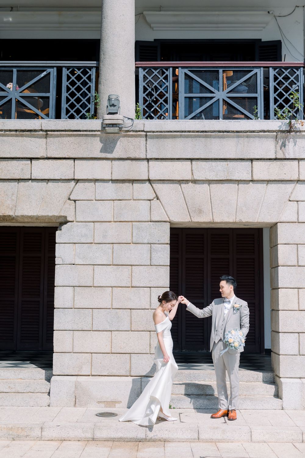 A series of romantic wedding photos captured against a classic stone building exterior.