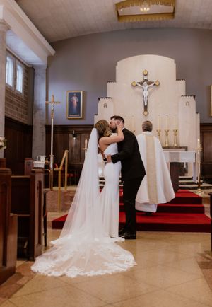 Bride and groom first kiss at St. Thomas Aquinas Church in Halifax, Nova Scotia