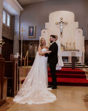 Bride and groom first kiss at St. Thomas Aquinas Church in Halifax, Nova Scotia
