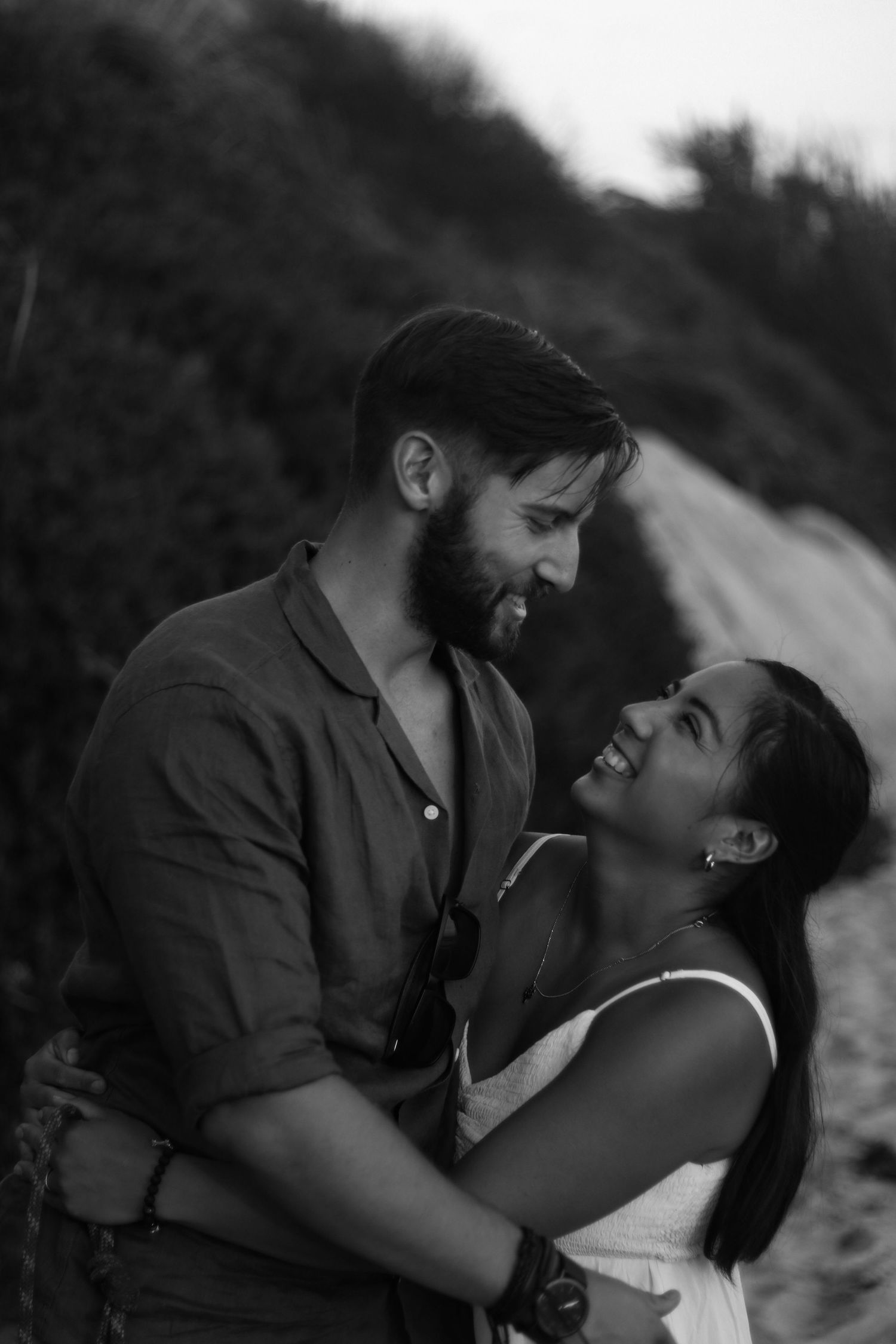 Couple smiling at each other at Sunset on the beach in Oceanside, California