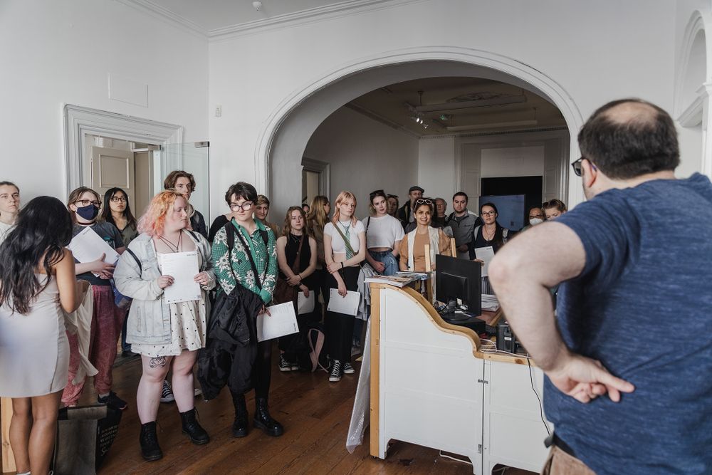 photo of a Galway international arts festival volunteers meeting with an artist at the arts centre in Galway