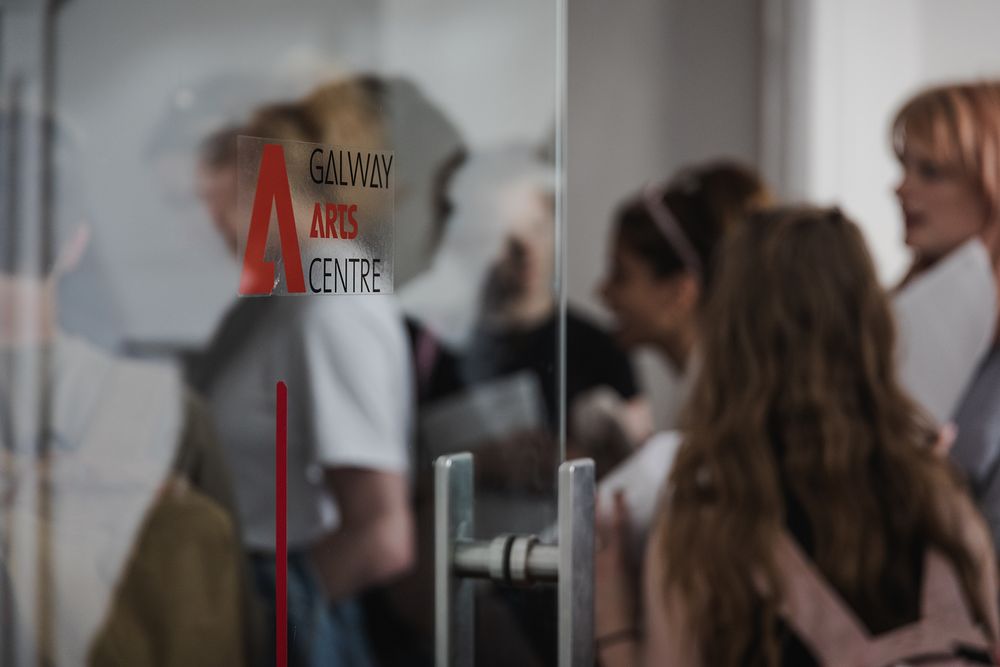photo of a Galway international arts festival volunteers meeting with an artist at the arts centre in Galway