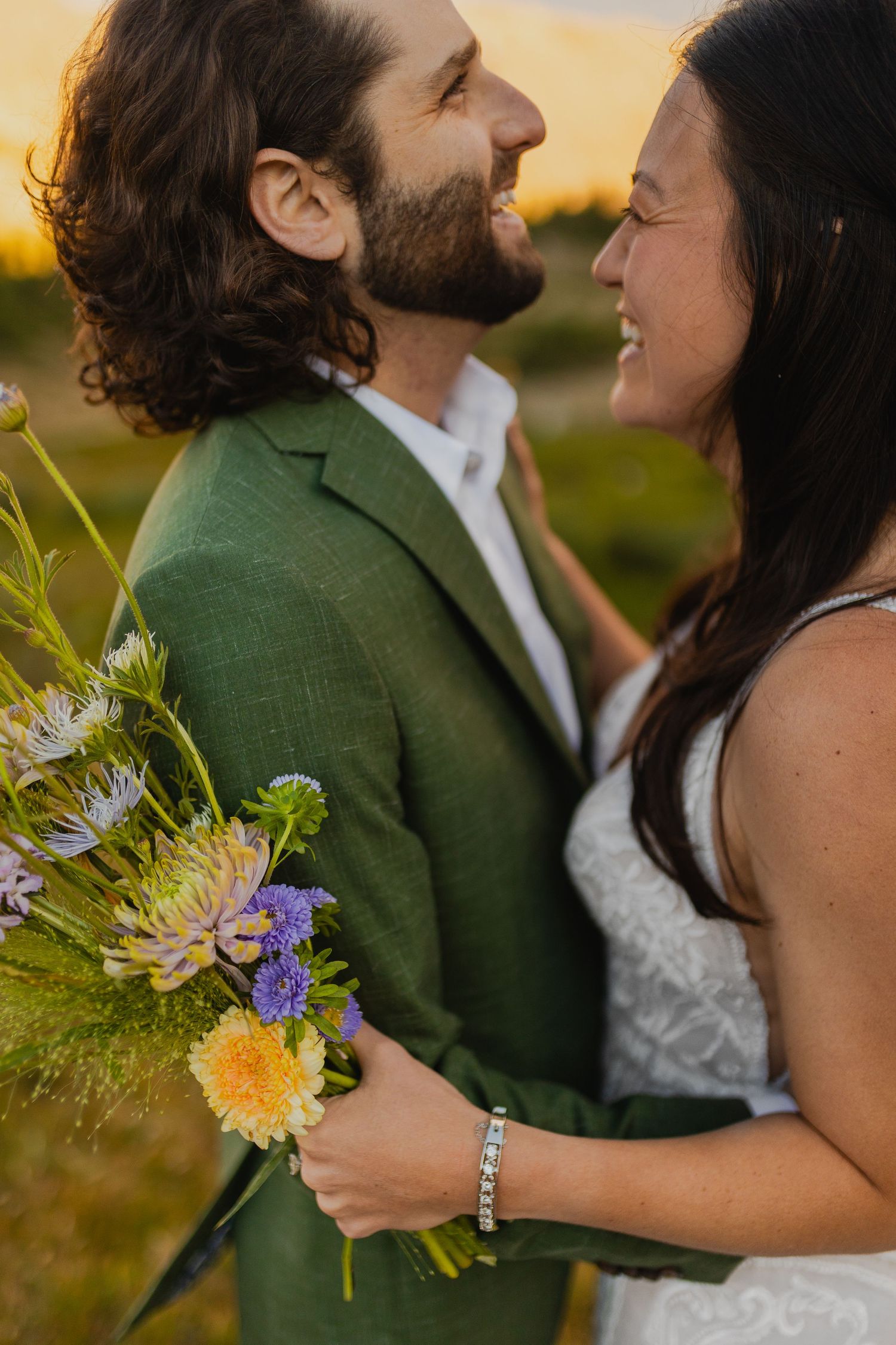 A tender moment between the newlyweds with the Colorado Rockies as a backdrop