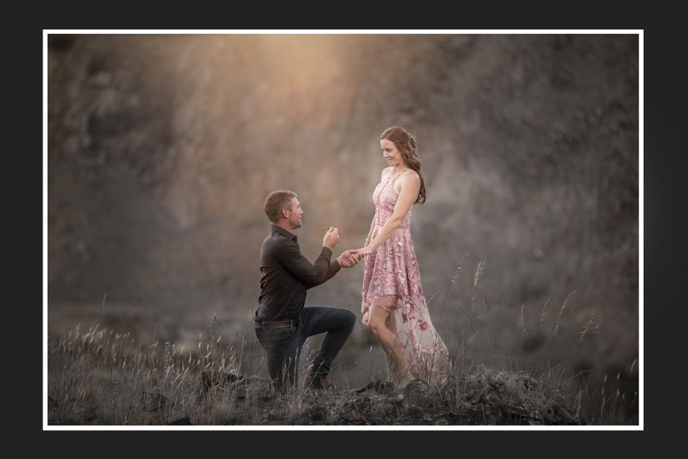 A romantic marriage proposal moment captured in a misty outdoor setting.