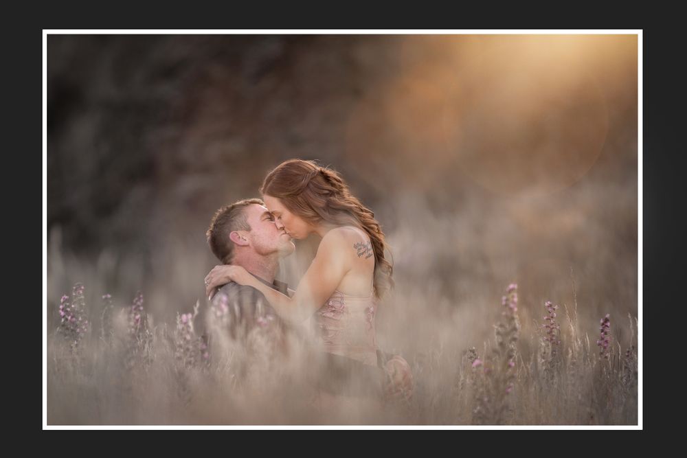 A romantic moment captured in a field of wildflowers during golden hour.