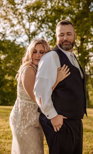 Playful and affectionate outdoor portrait session with warm sunset lighting.