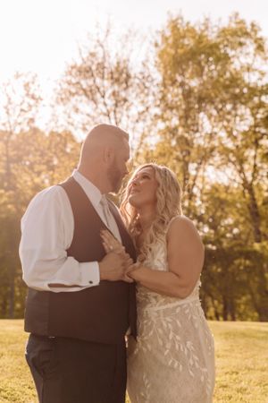 Romantic sunset portrait session in a meadow with warm golden lighting.