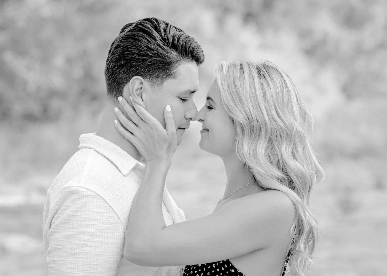Intimate black and white portrait capturing a tender romantic moment.