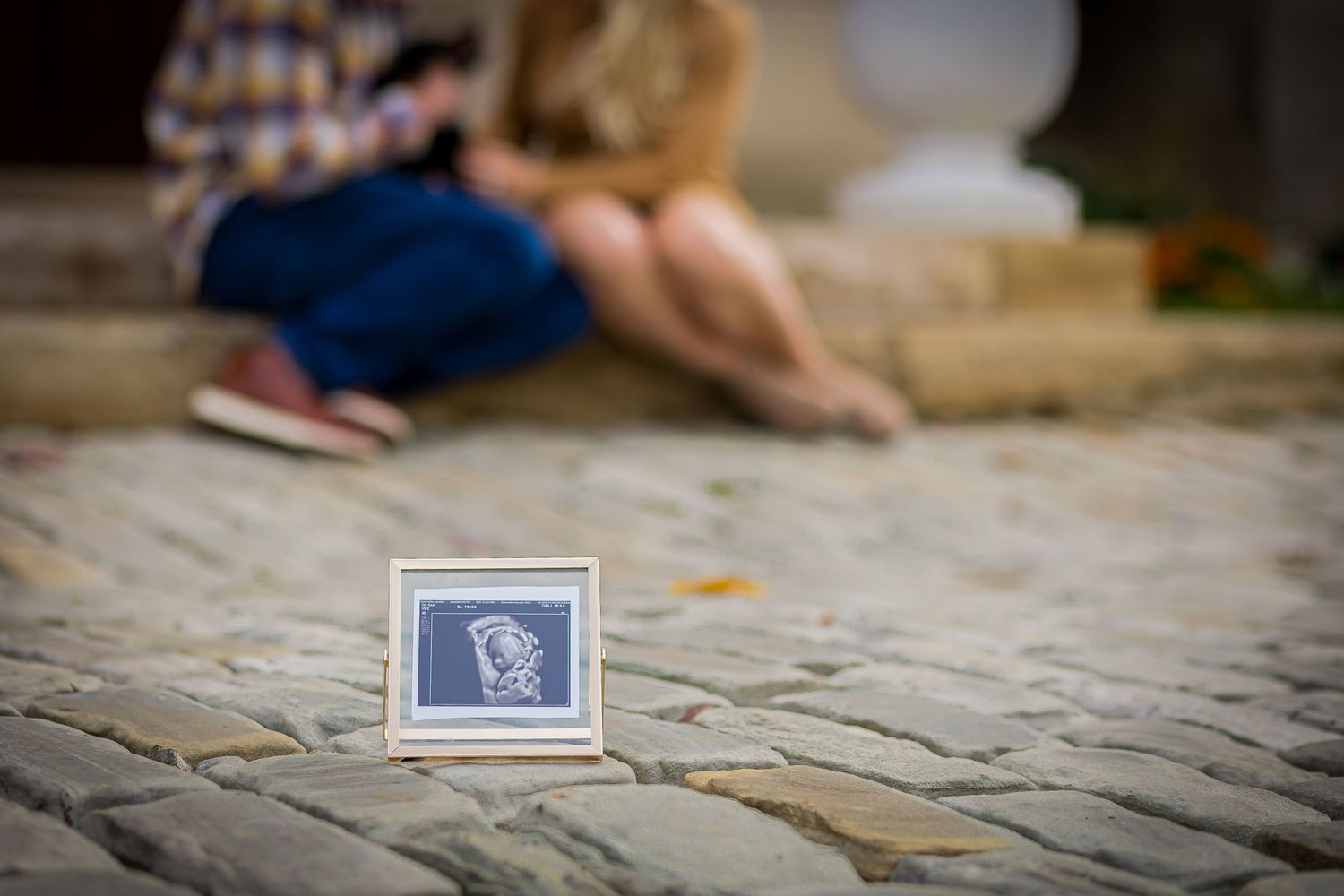 A couple shares a sweet pregnancy announcement. Artful and creative images