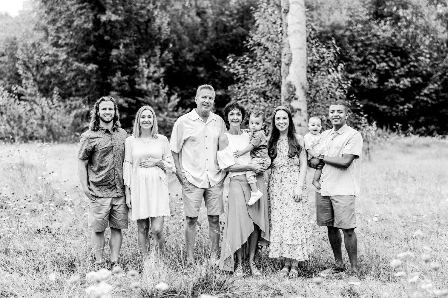 black and white photo classic portrait of extended family in a field