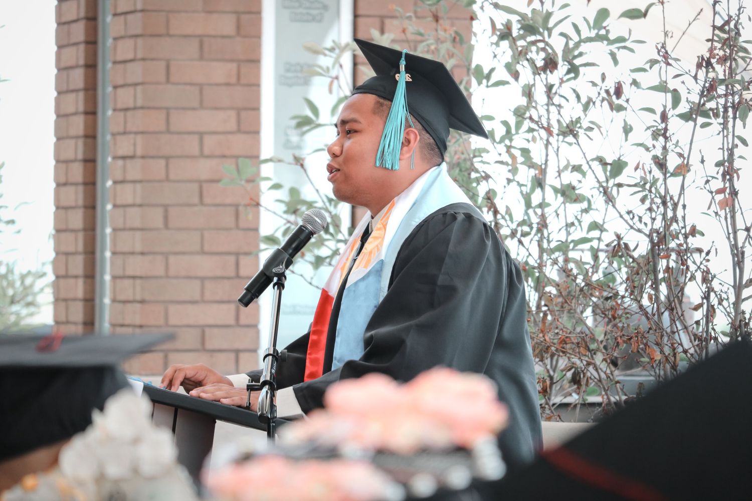 Professional college graduation portrait of a student celebrating commencement with natural lighting in Fresno, California